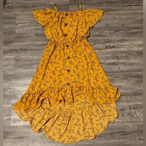 Mustard yellow dress with red flowers, short front long in back.